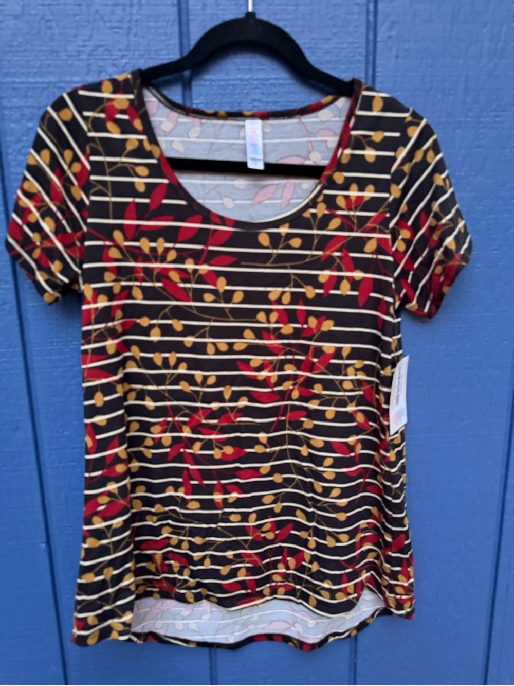 LuLaRoe Black Scoop Neck Tee with Red & Mustard Leaf Stripe Print